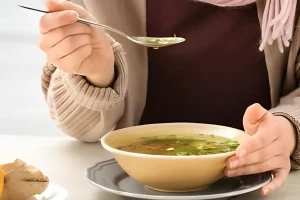 Variety of chicken broth options displayed on a kitchen counter