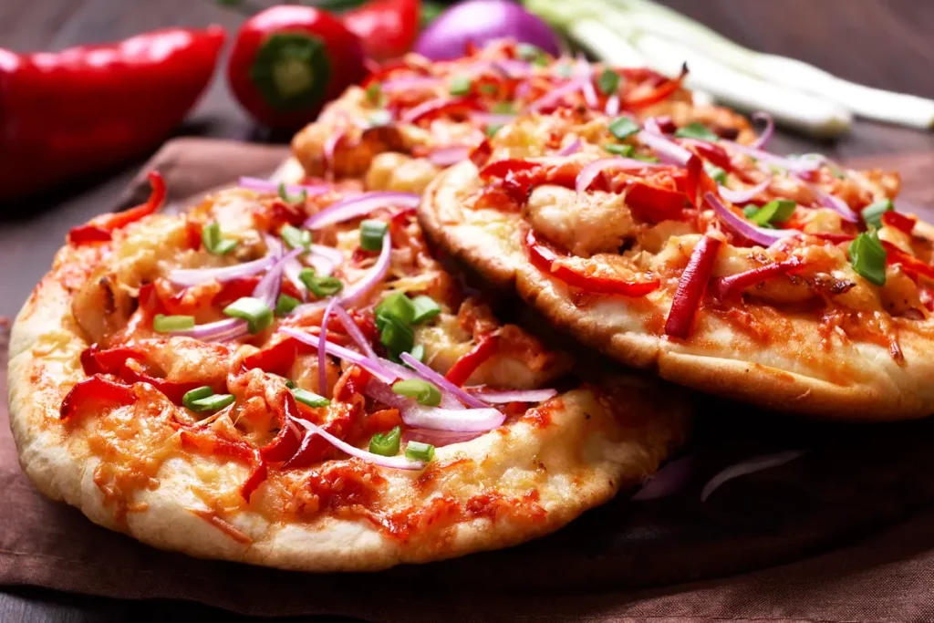 Delicious homemade naan pizza topped with fresh ingredients and melted cheese.