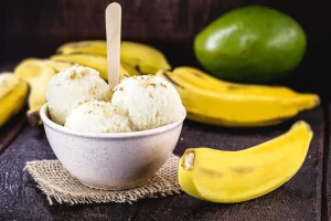 Close-up of a spoonful of banana pudding with a vanilla wafer garnish - Delicious Banana Pudding Bite