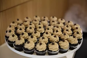 Decorating mini cupcakes with frosting