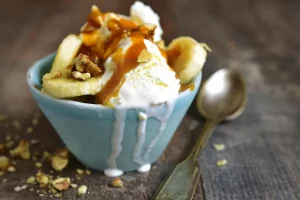 Creamy banana pudding ice cream in a bowl topped with vanilla wafers