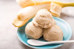 Close-up of a scoop of creamy banana pudding ice cream on a cone