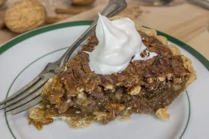 Sliced pecan cream pie with whipped cream