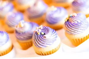 Close-up of mini cupcake batter being scooped into liners