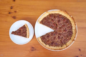 Sliced pecan pie served on a decorative plate