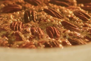 Pecan pie filling being poured into a pie crust