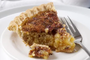 Freshly baked pecan pie with golden brown crust and glistening filling