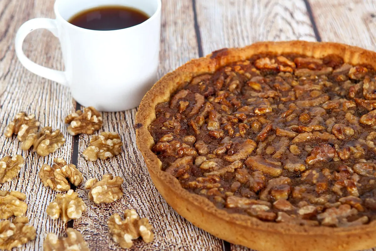 Close-up of golden-brown, flaky pecan pie crust