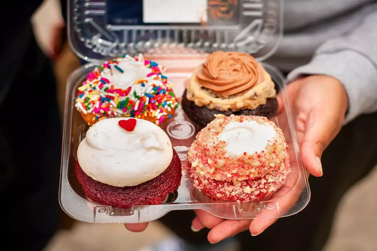 Cupcakes securely packed in a cardboard bakery box